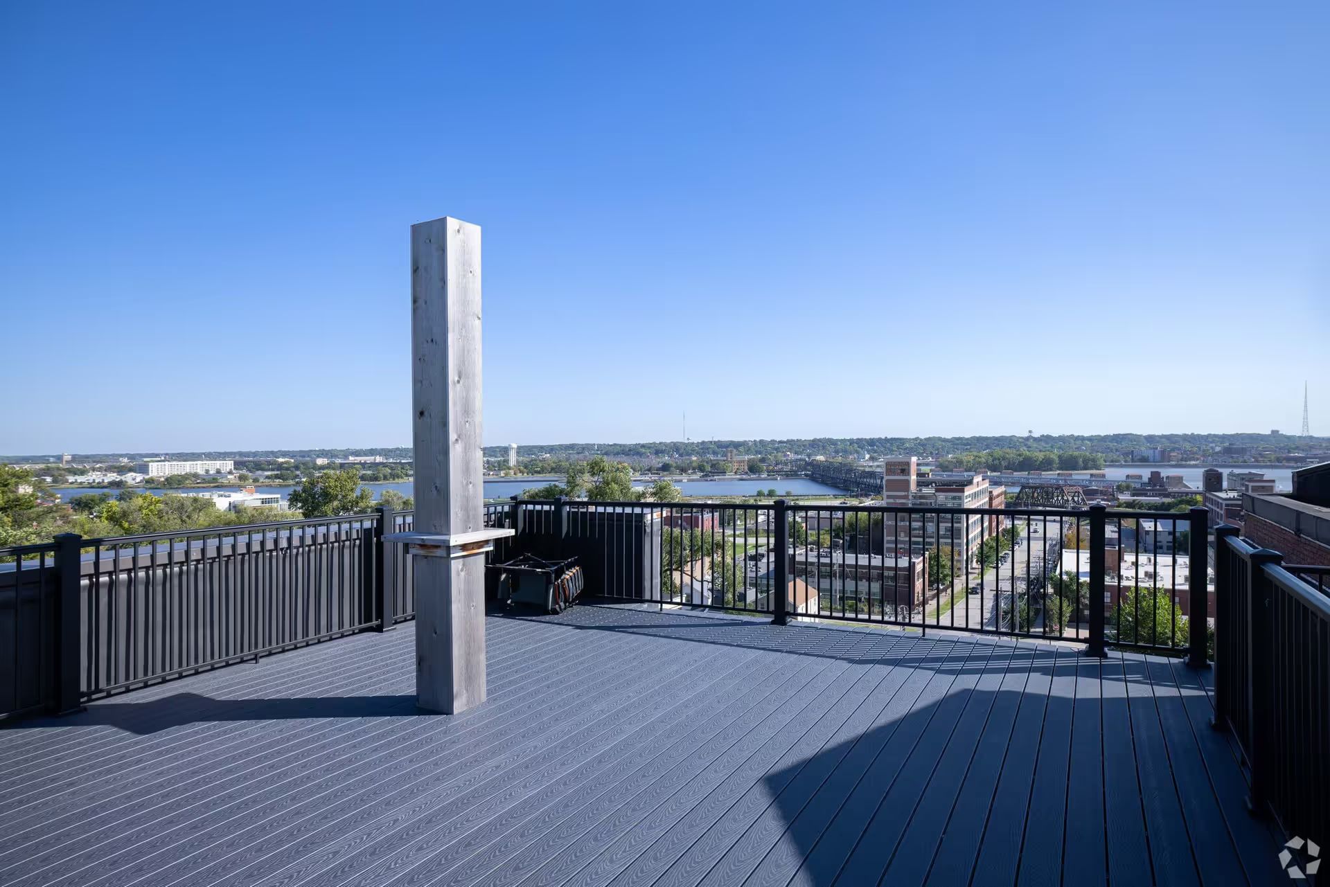 A balcony with a view of a city and a river.