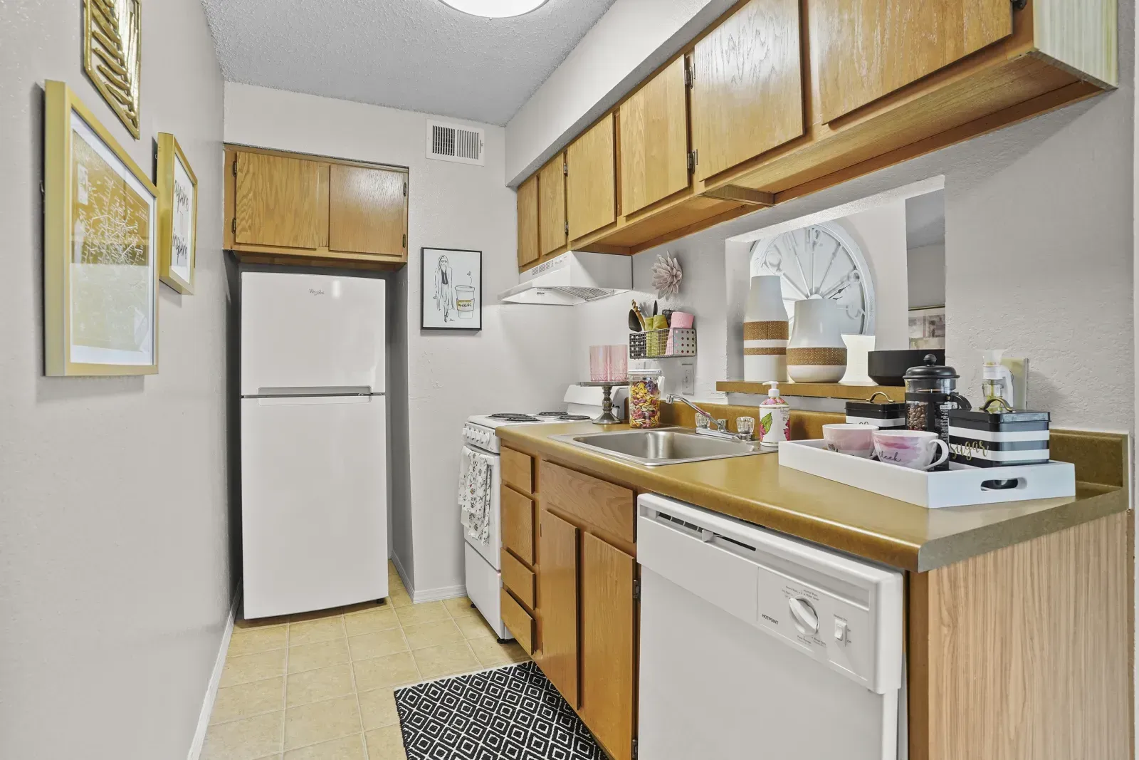 Bright kitchen area with wooden cabinets and appliances