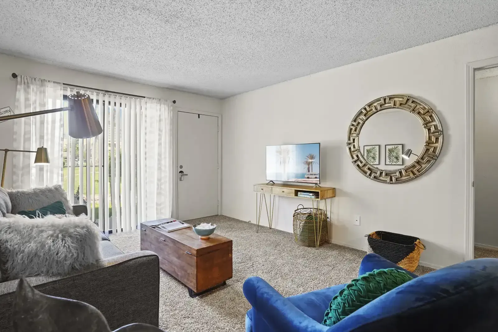 Cozy living room with a blue chair and wooden coffee table