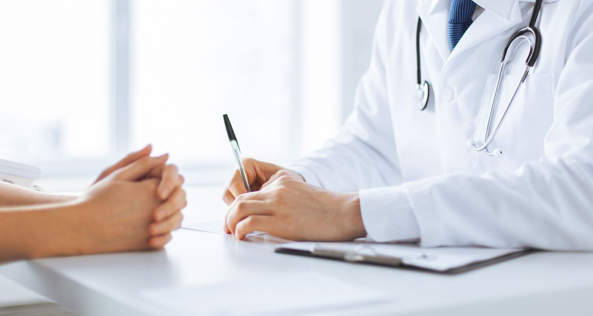 Doctor consulting with patient during QME exam preparation and medical evaluation process. Doctor consulting with patient during QME exam preparation and medical evaluation process.