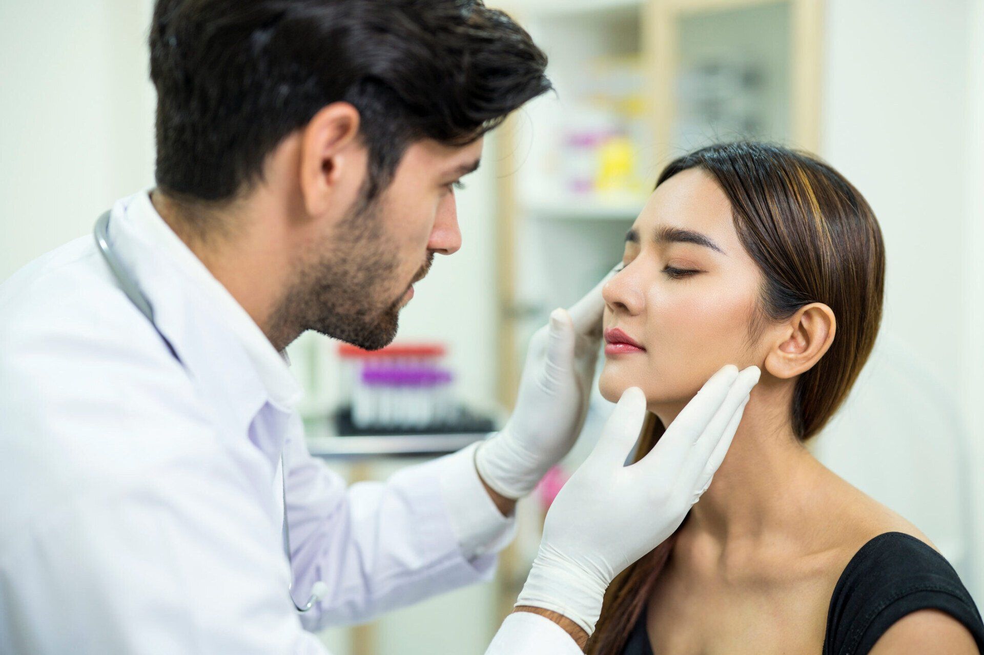 Doctor Examining And Explaining Asian Women Patient's Face — Costa Mesa, CA — Affiliated Medical Evaluators, Inc.