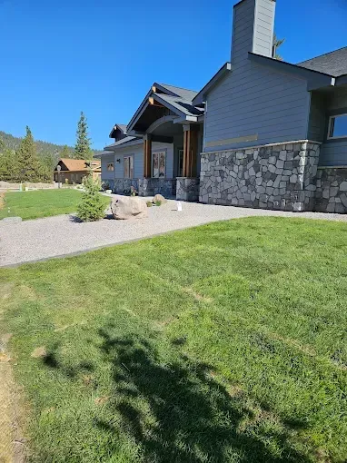 A large house with a large lawn in front of it.