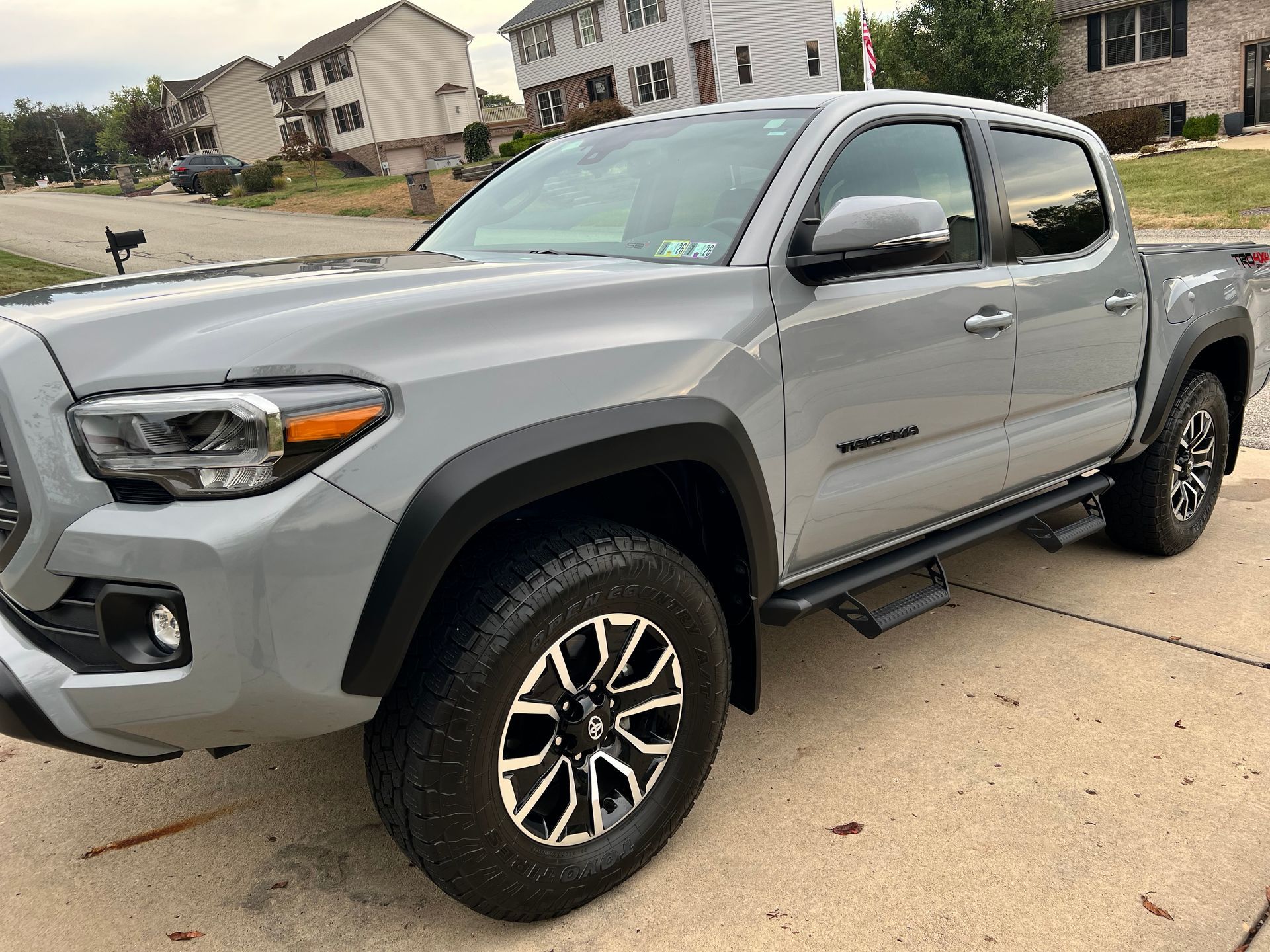 Gray Toyota Tacoma truck parked on a driveway in a residential neighborhood.