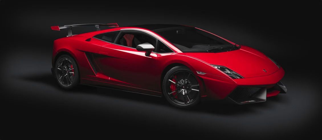 Red Lamborghini sports car on a dark background.