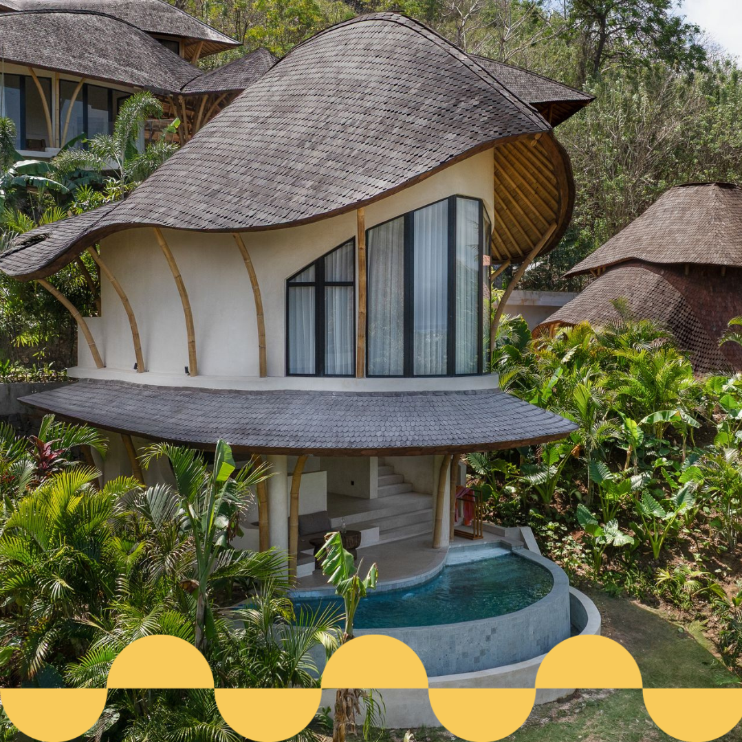A unique bamboo-style house with a thatched roof, featuring a pool and surrounded by lush greenery.
