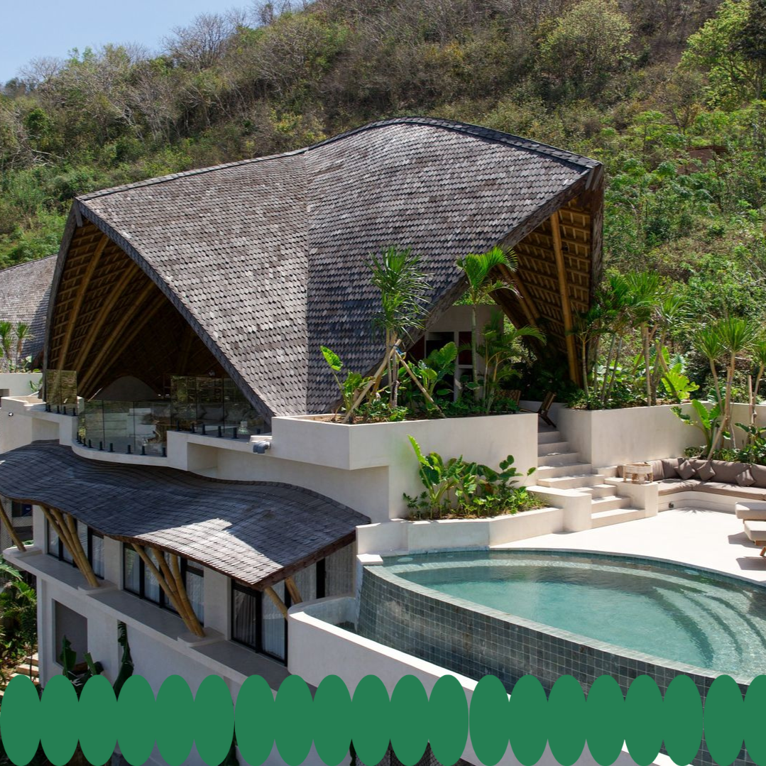 Modern building with a unique, curved roof, pool, and surrounding hillside.
