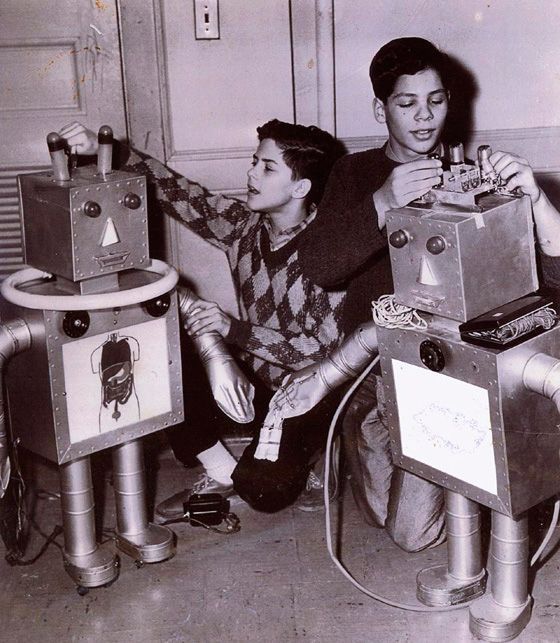A Black And White Photo Of Two Boys Working On Robots - San Rafael, CA - Tarlow Design LLC