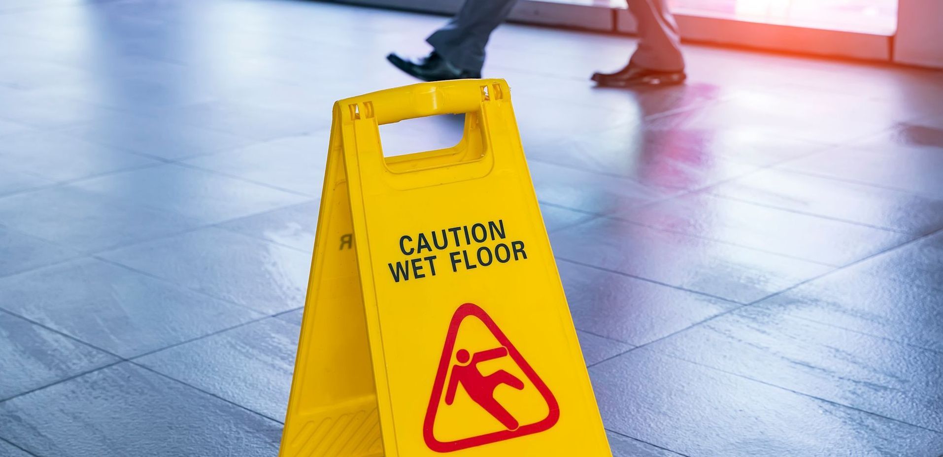 A man is walking down a set of stairs in an office.