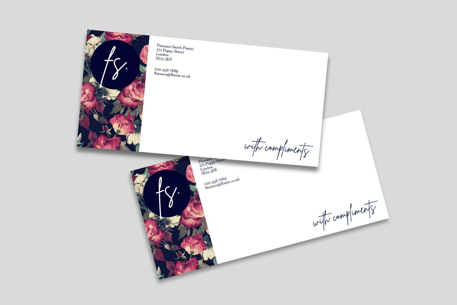 A couple of business cards with a floral design on them