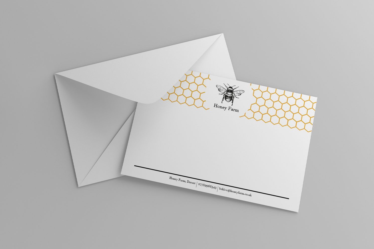 A white envelope with a bee and honeycomb on it.