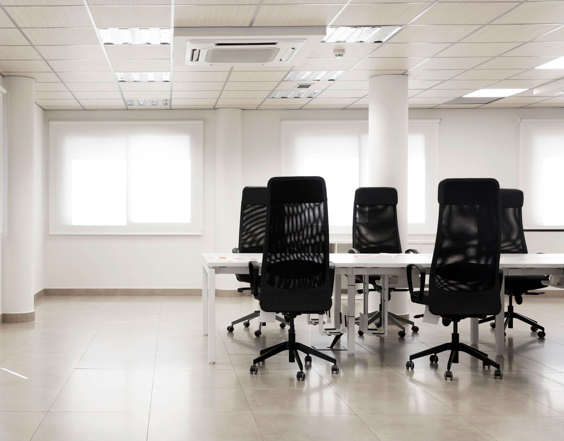 A conference room with a table and chairs in it.