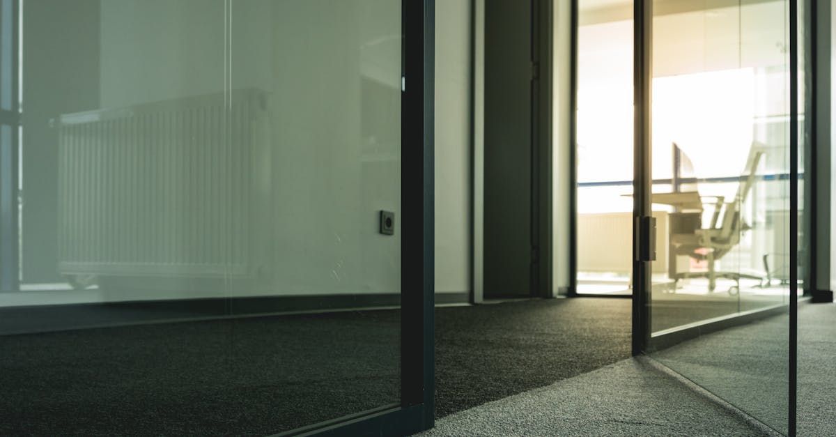 A room with a glass wall and a chair in it.