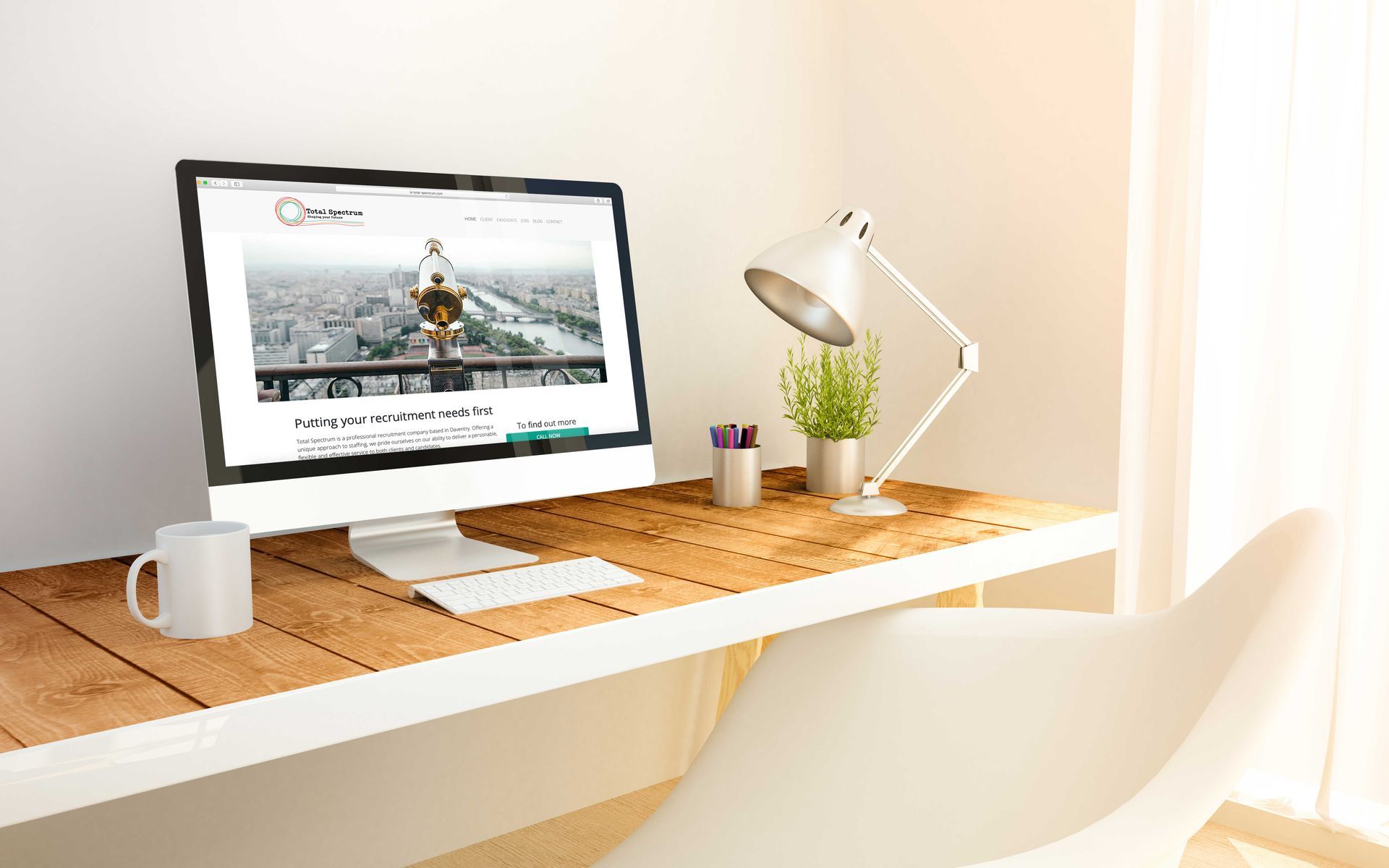 A computer is sitting on a wooden desk next to a lamp.