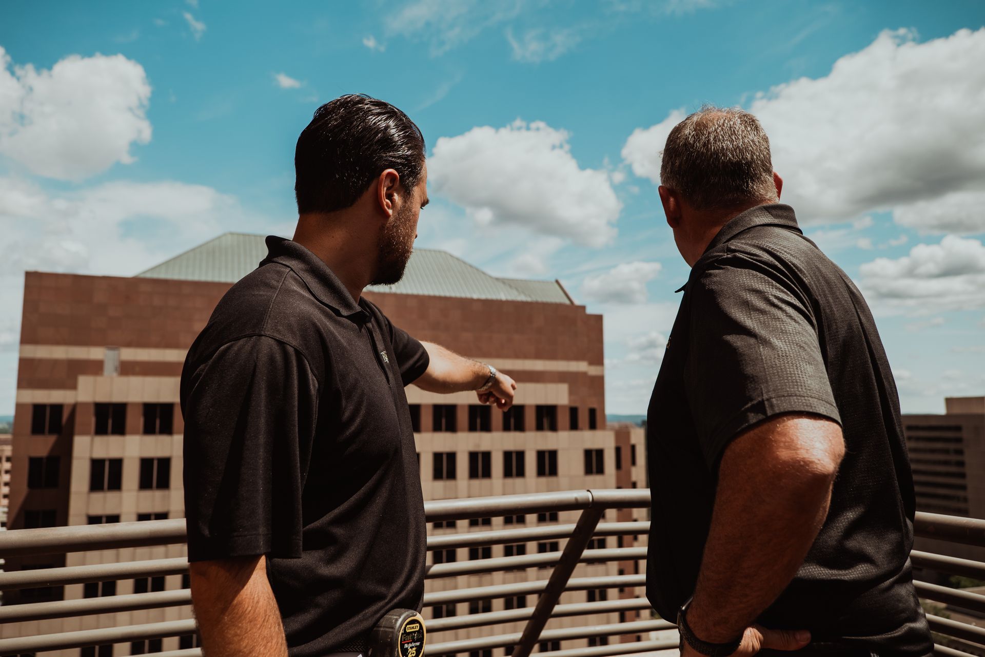 A man is writing on a piece of paper with a pen.