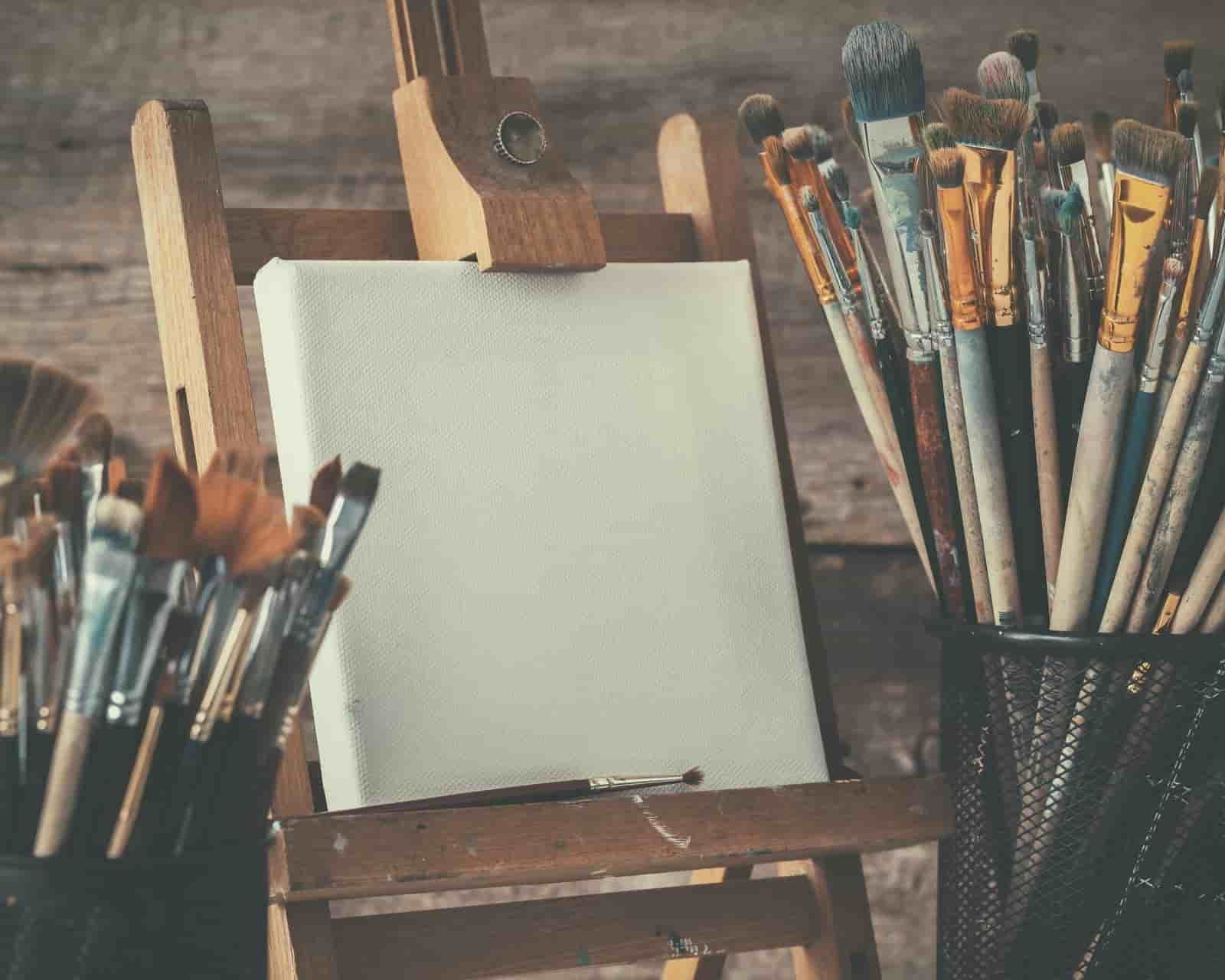 An easel with a canvas and brushes on it