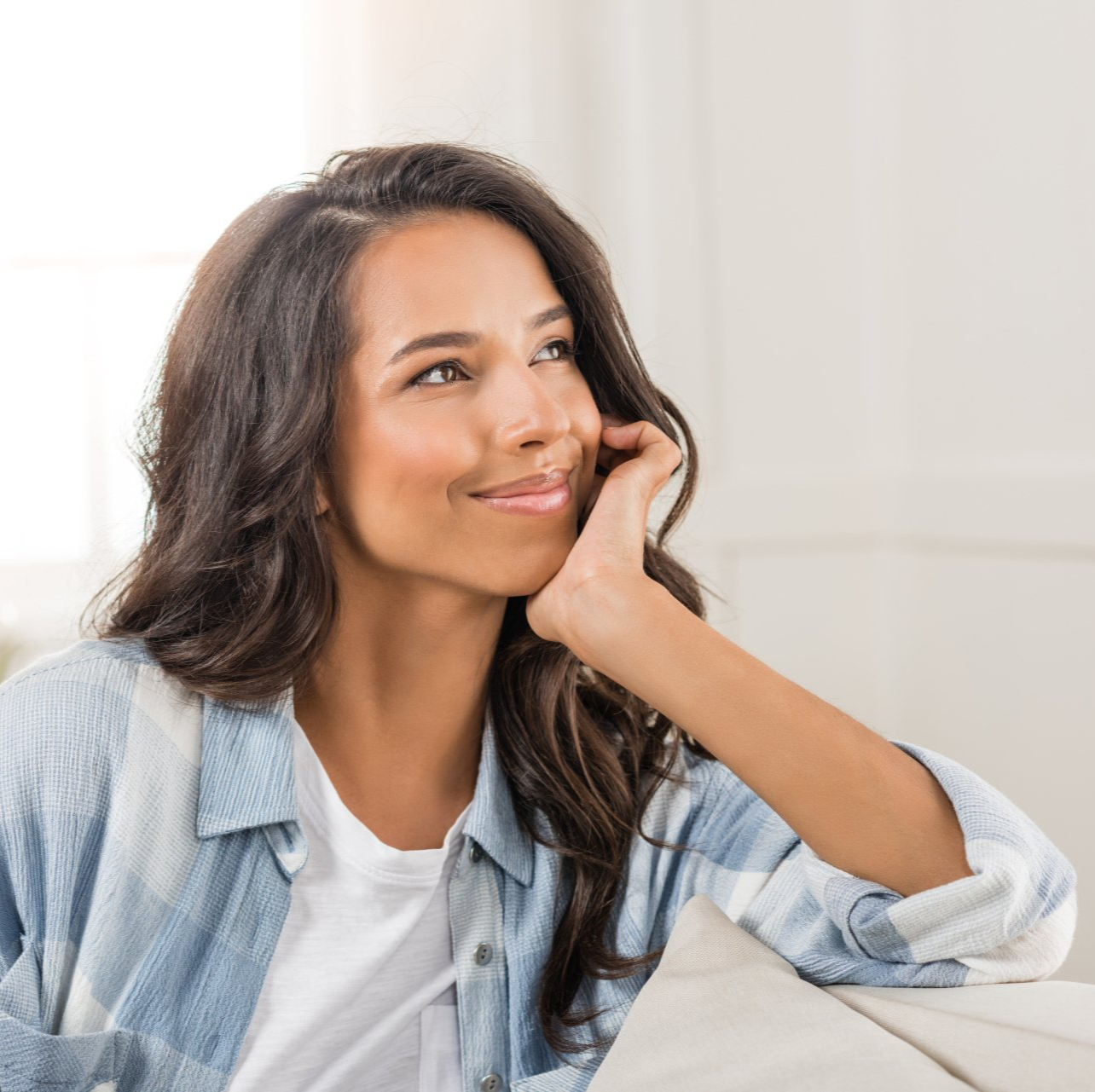 Woman  siling with hand on face