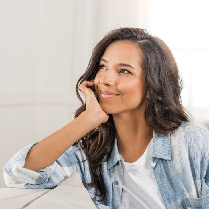 Woman  siling with hand on face