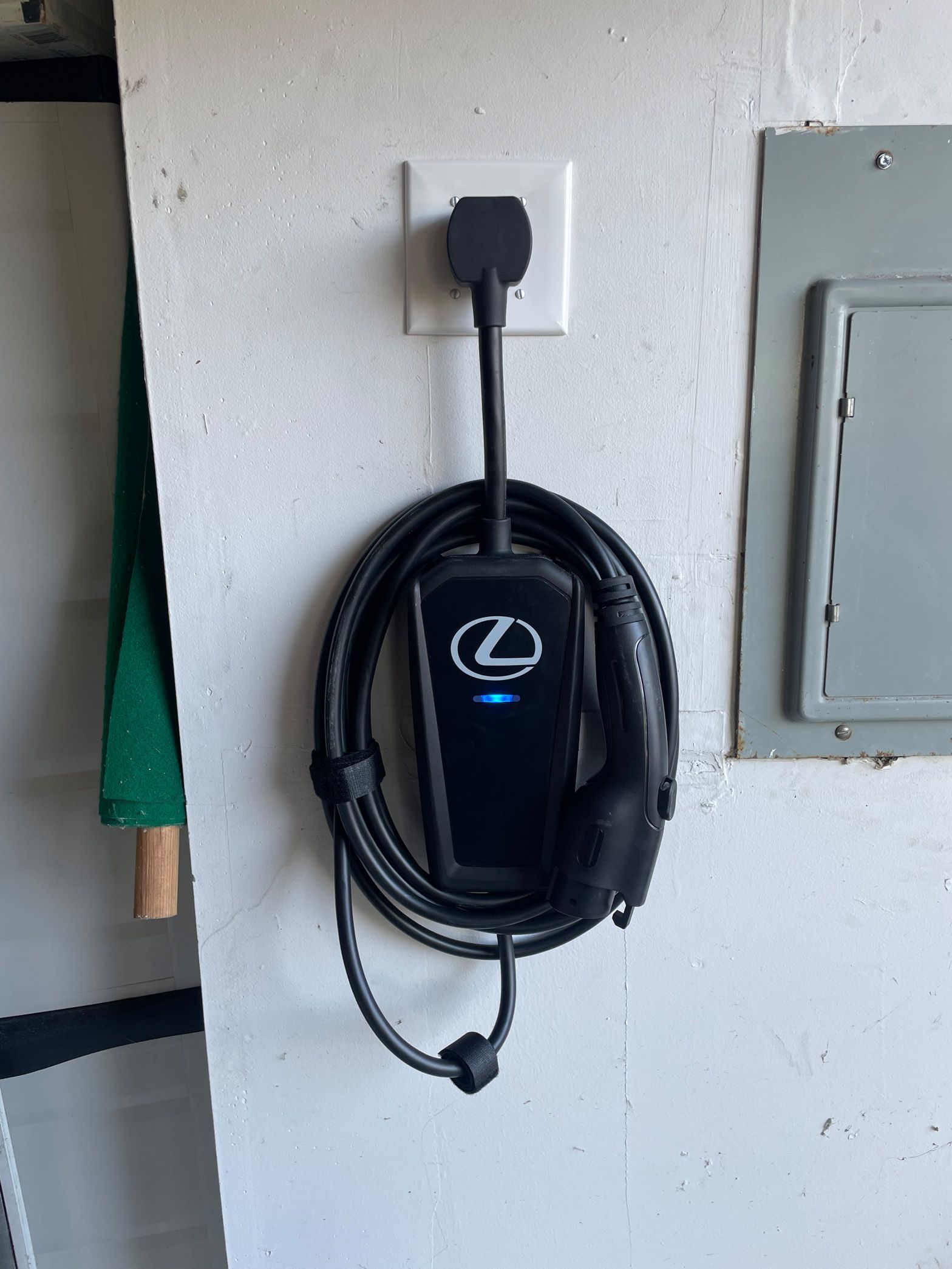 A lexus charger is plugged into a wall outlet