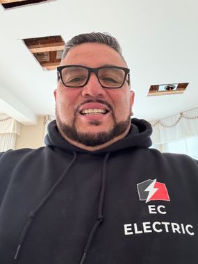 A man wearing glasses and a hoodie that says ec electric