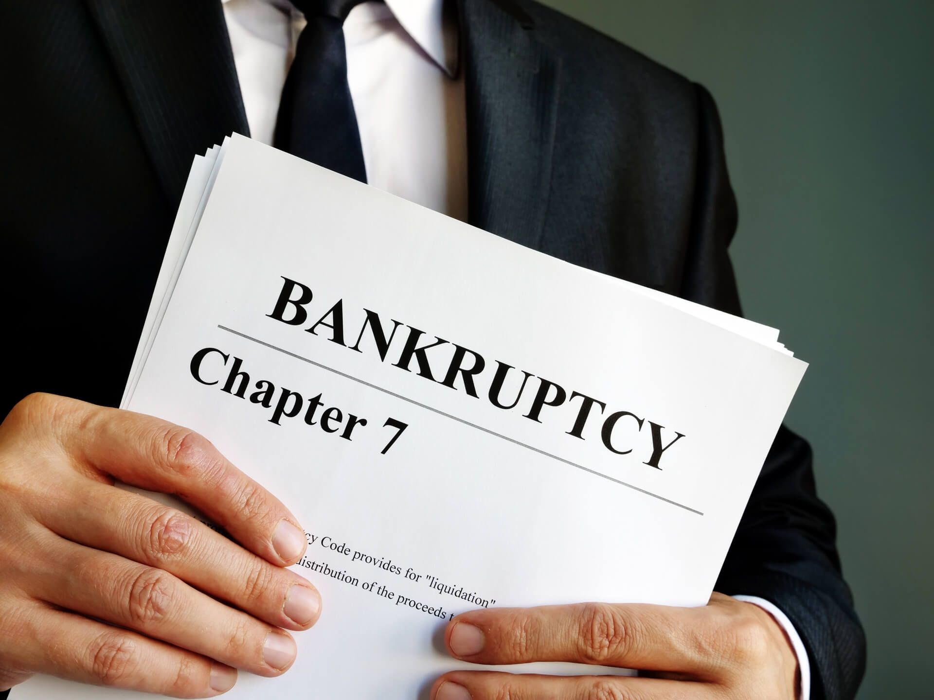 Holding a Book Titled Bankruptcy Chapter 7