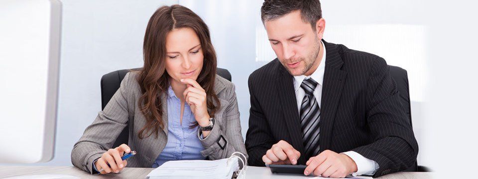 Man and Woman Looking at a Document