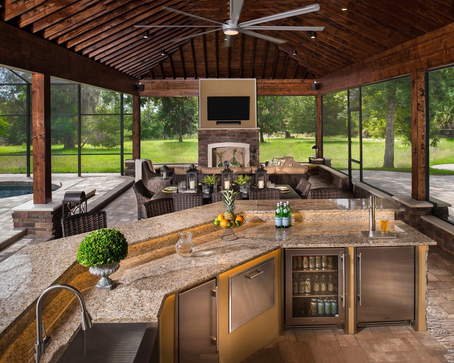 A kitchen with granite counter tops and a stainless steel refrigerator