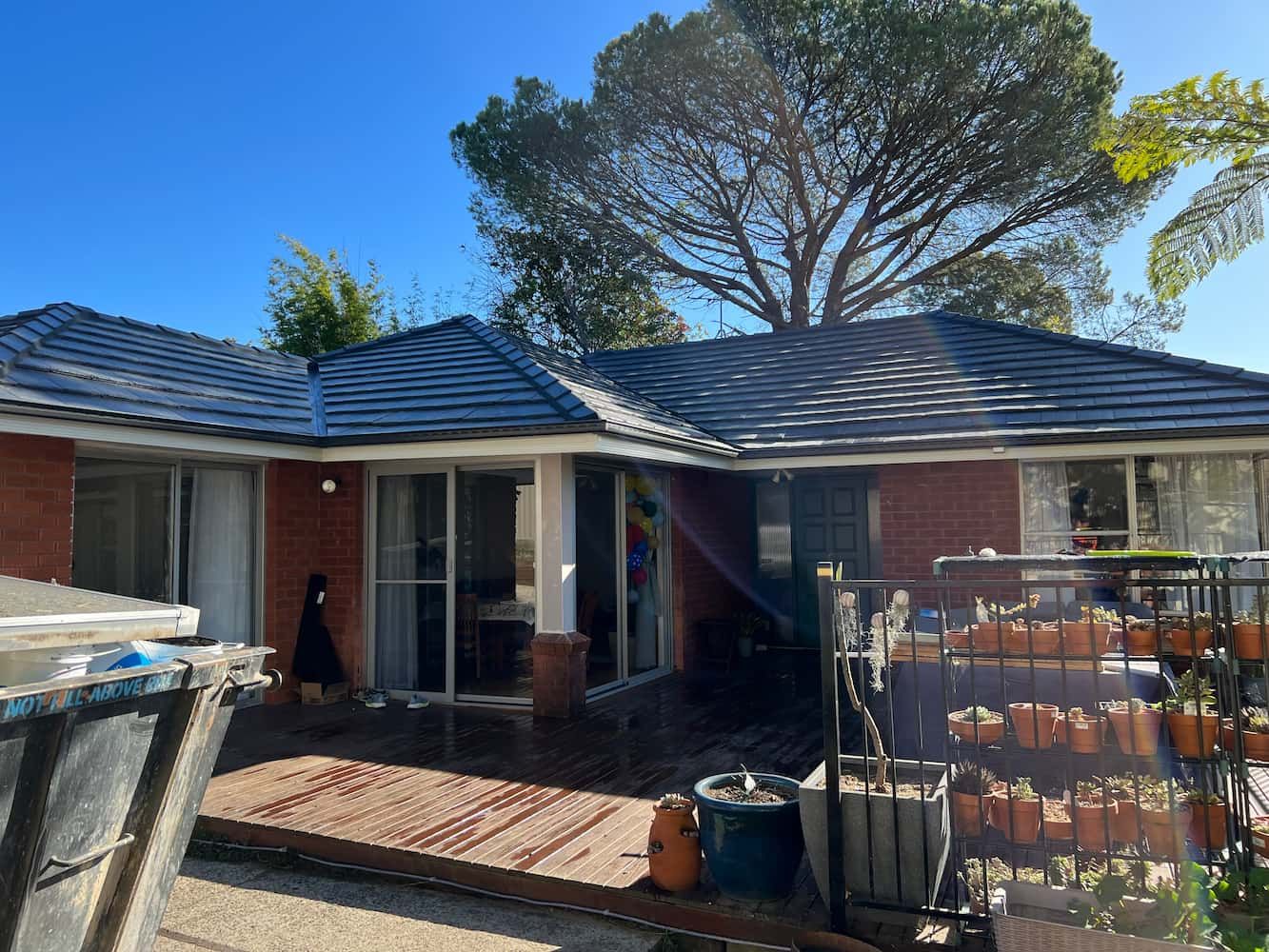 A Brick House With a Slate Roof and a Tree in the Background — DC Roofing In Marsden Park, NSW