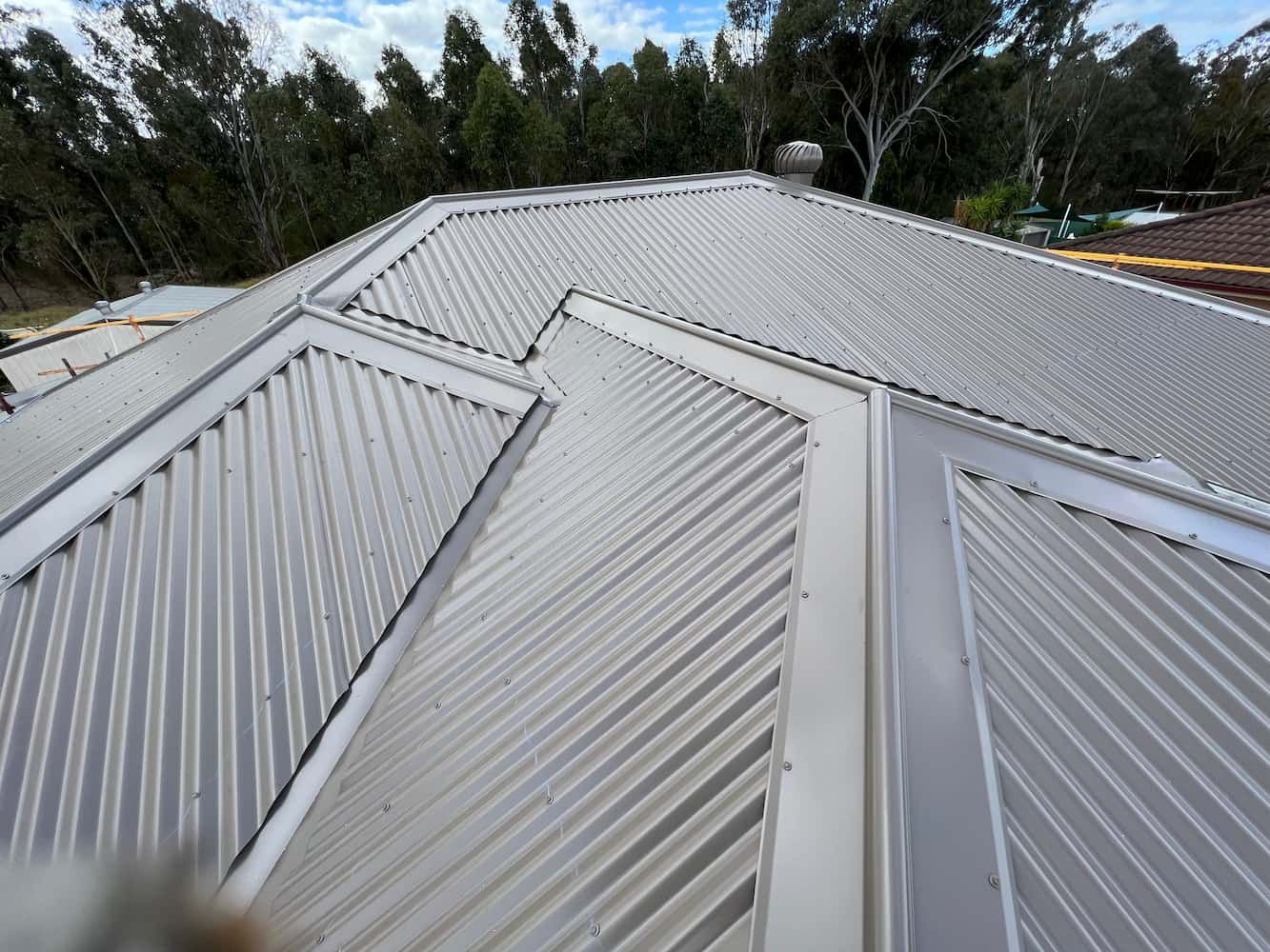 A Close Up of a White Roof With Trees in the Background — DC Roofing In Marsden Park, NSW