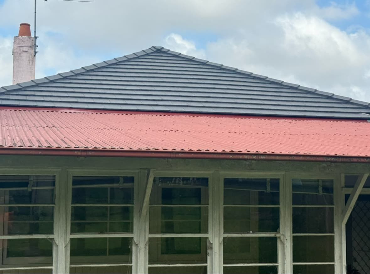 A House With a Red Roof and White Windows — DC Roofing In Concord, NSW