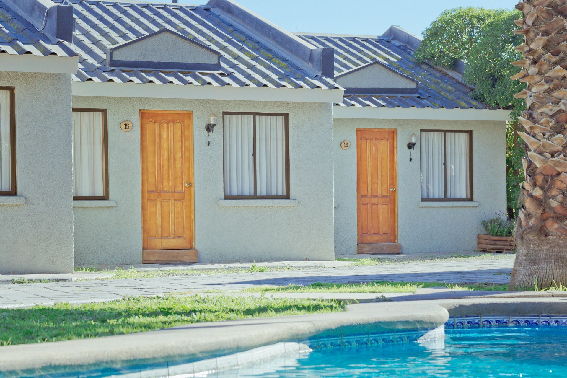 A row of houses with a pool in front of them
