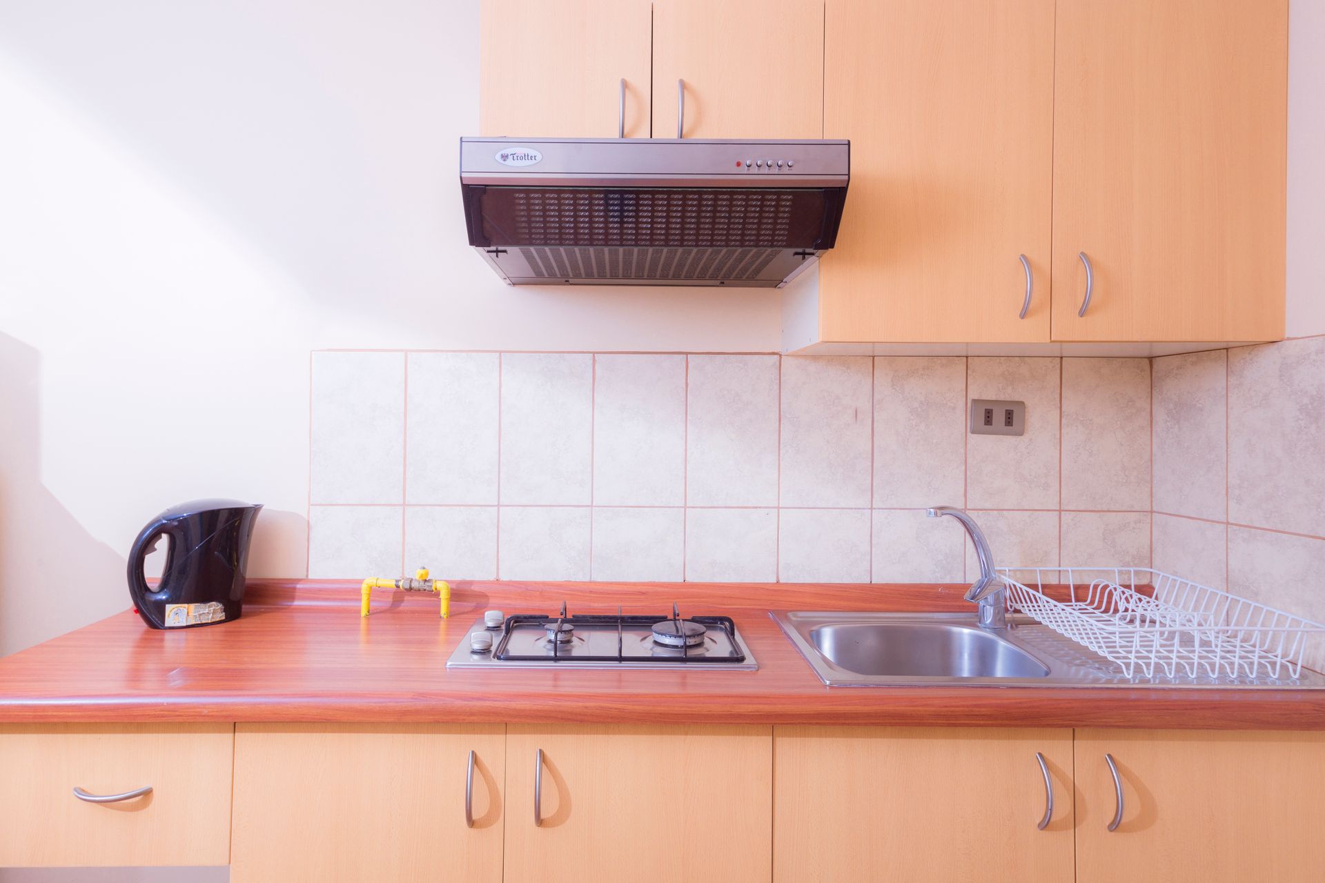 A kitchen with a stove top oven and a sink