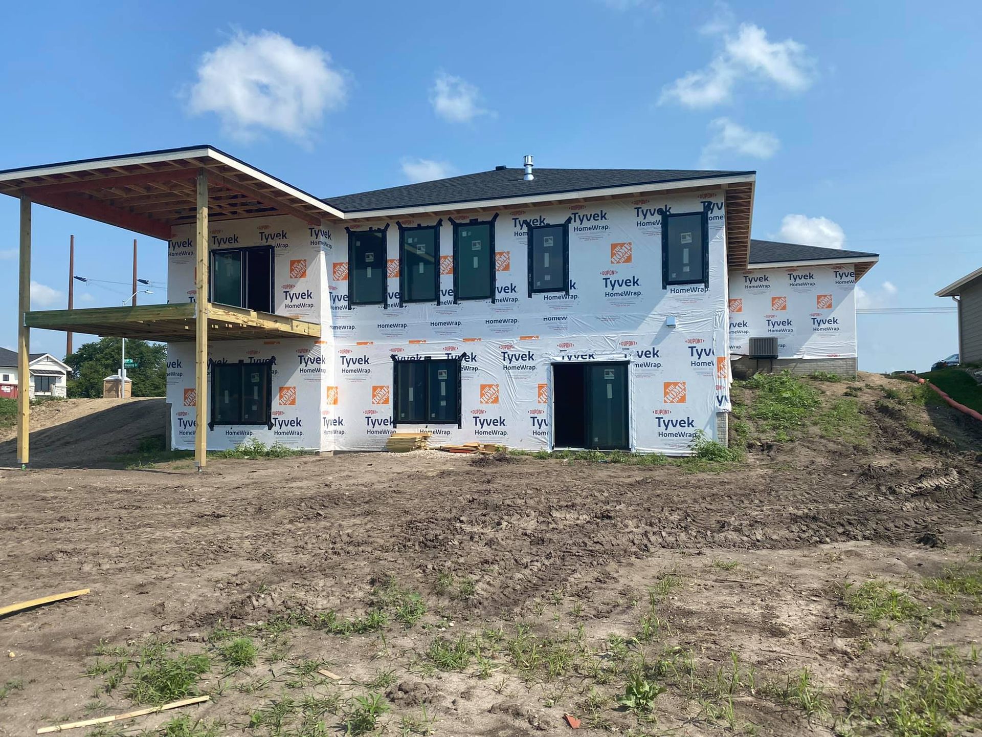 A large house under construction with a lot of windows