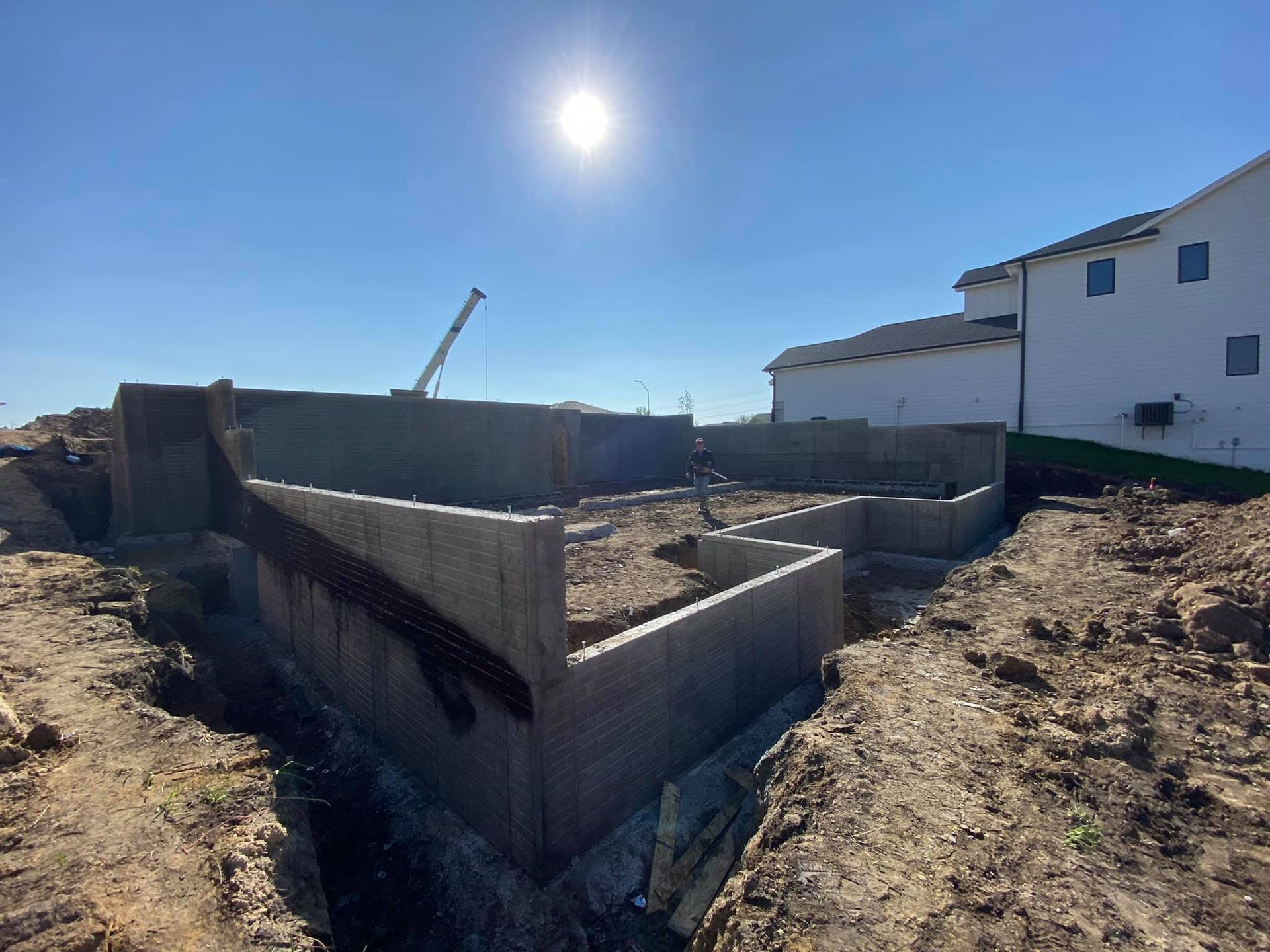 A foundation for a house is being built in a dirt field.