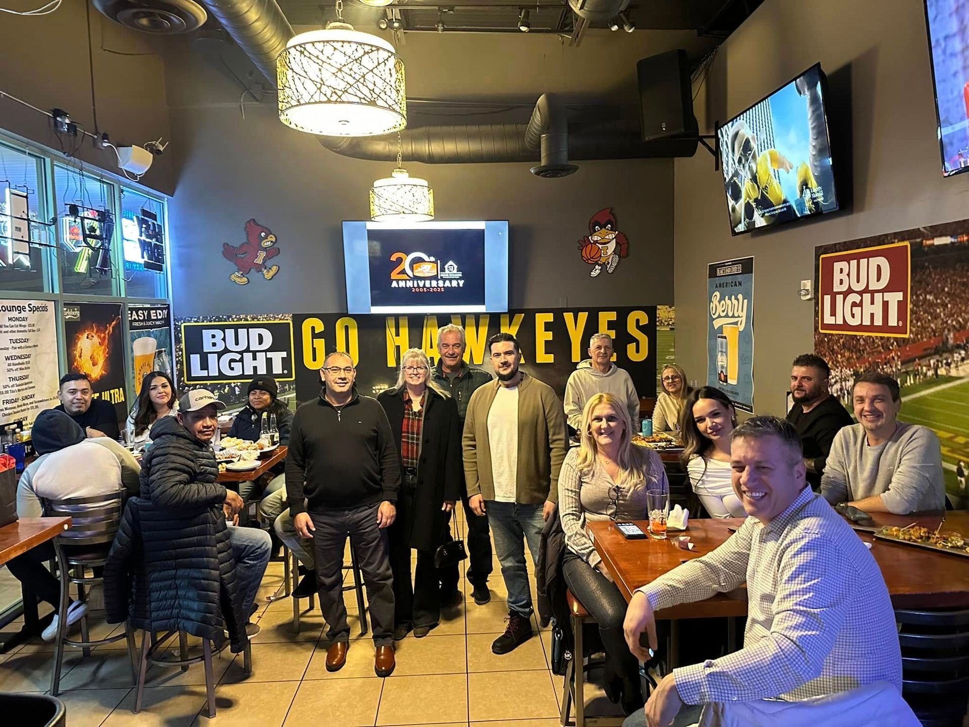 A group of people are posing for a picture in a restaurant.