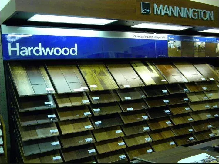 Display of Mannington Hardwood flooring samples in various colors and finishes.