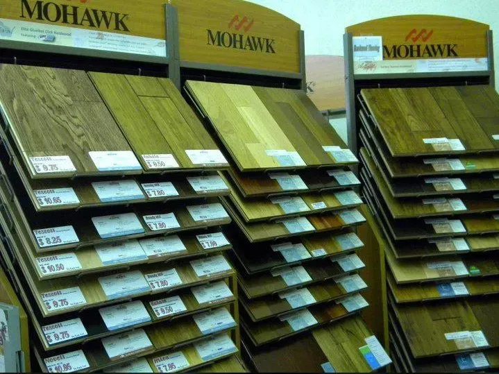 Mohawk hardwood flooring samples displayed on racks in a store.