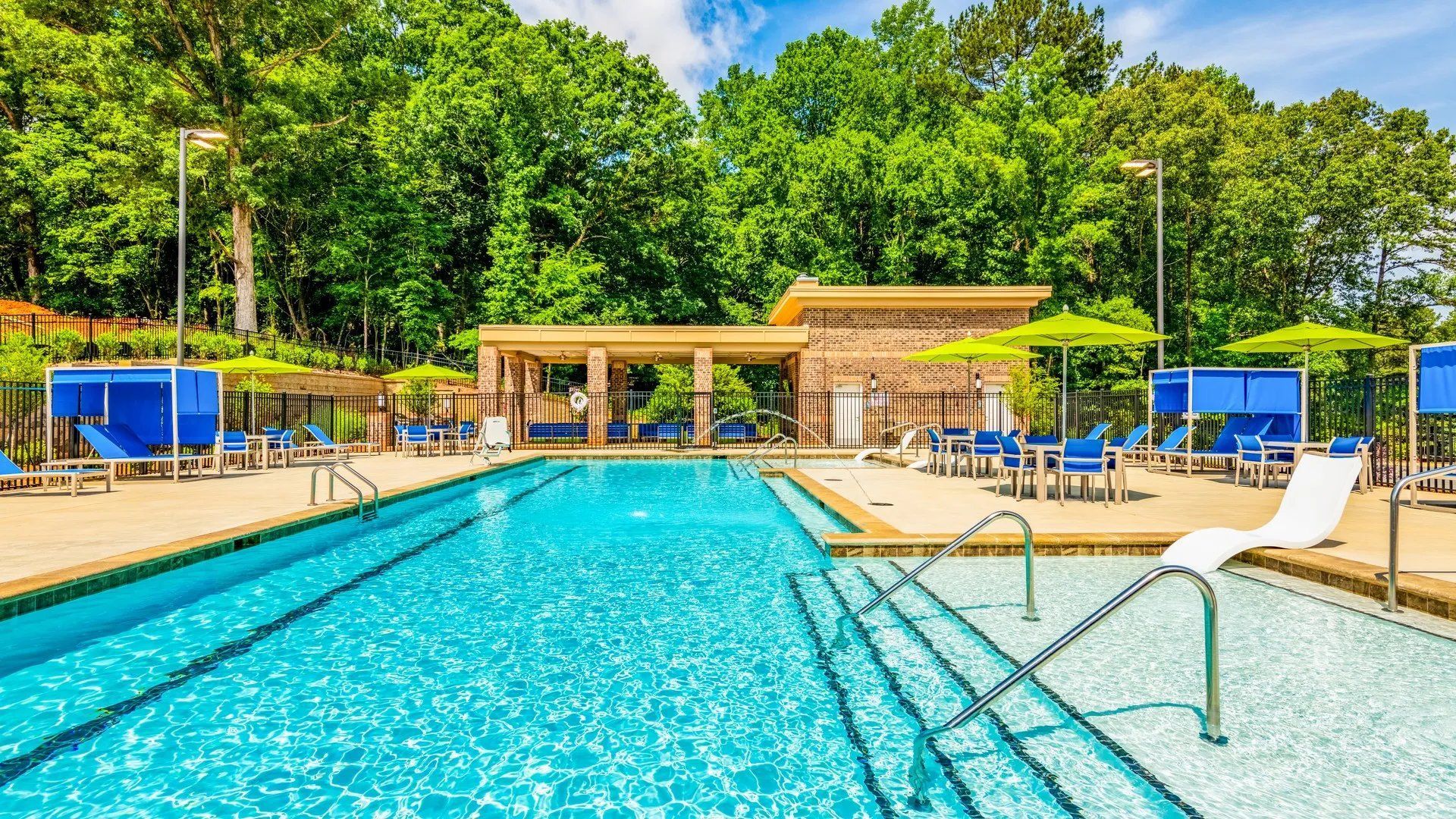 Vibrant pool area with lounge chairs and shaded seating. Our Wexhaw, NC apartments provide the best in luxury living in downtown Waxhaw. Ready to make our community your home? Contact Waxhaw Mills today to learn more and schedule your personalized tour!