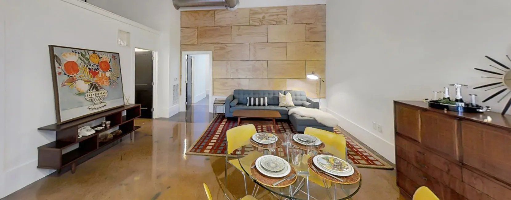 Modern apartment living area with a dining set and couch. Interested in learning more about our 1, 2, and 3-bedroom apartments in Waxhaw, NC? Contact us today to schedule your tour!