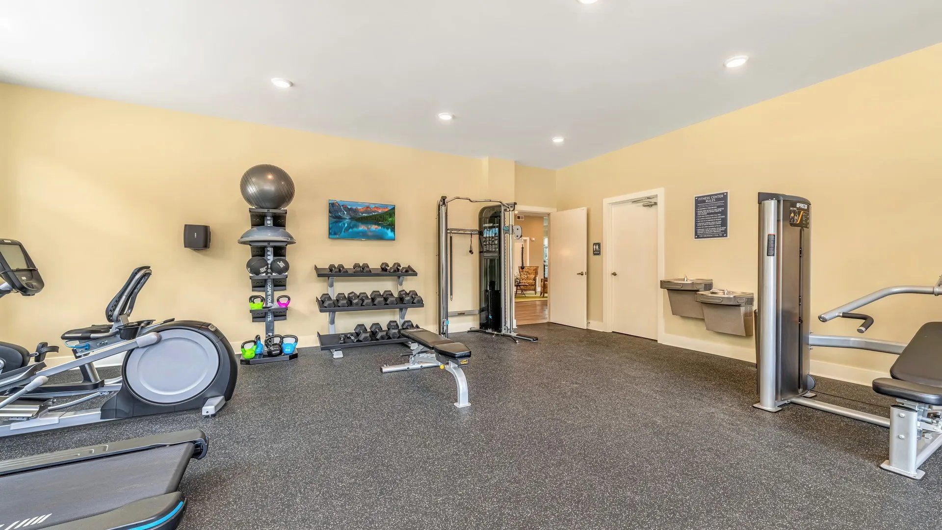 Interior view of a modern fitness center with exercise equipment. Our Wexhaw, NC apartments provide the best in luxury living in downtown Waxhaw. Ready to make our community your home? Contact Waxhaw Mills today to learn more and schedule your personalized tour!