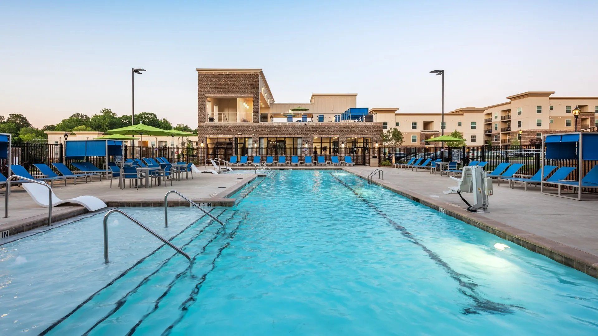Swimming pool area with lounge chairs and cabanas. Our Wexhaw, NC apartments provide the best in luxury living in downtown Waxhaw. Ready to make our community your home? Contact Waxhaw Mills today to learn more and schedule your personalized tour!