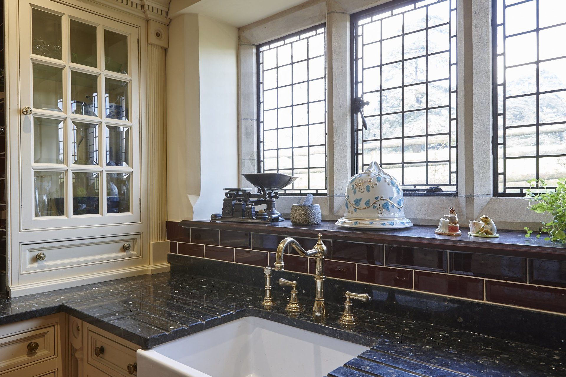 A kitchen with a sink and a window above it