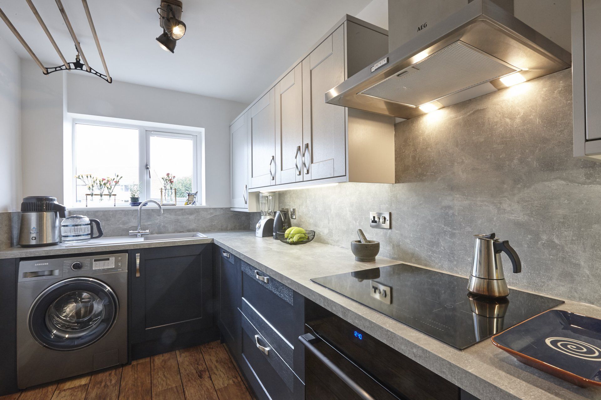 A kitchen with a stove top oven and a washer and dryer