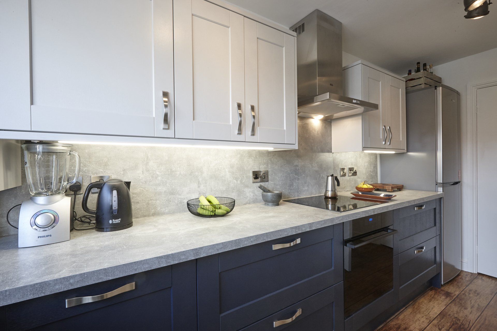 A kitchen with stainless steel appliances and white cabinets