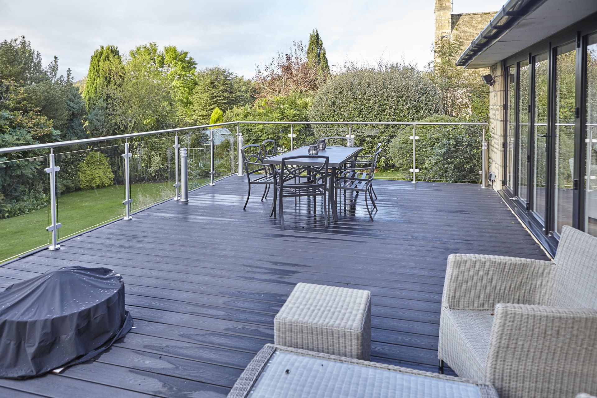 A large deck with a table and chairs on it