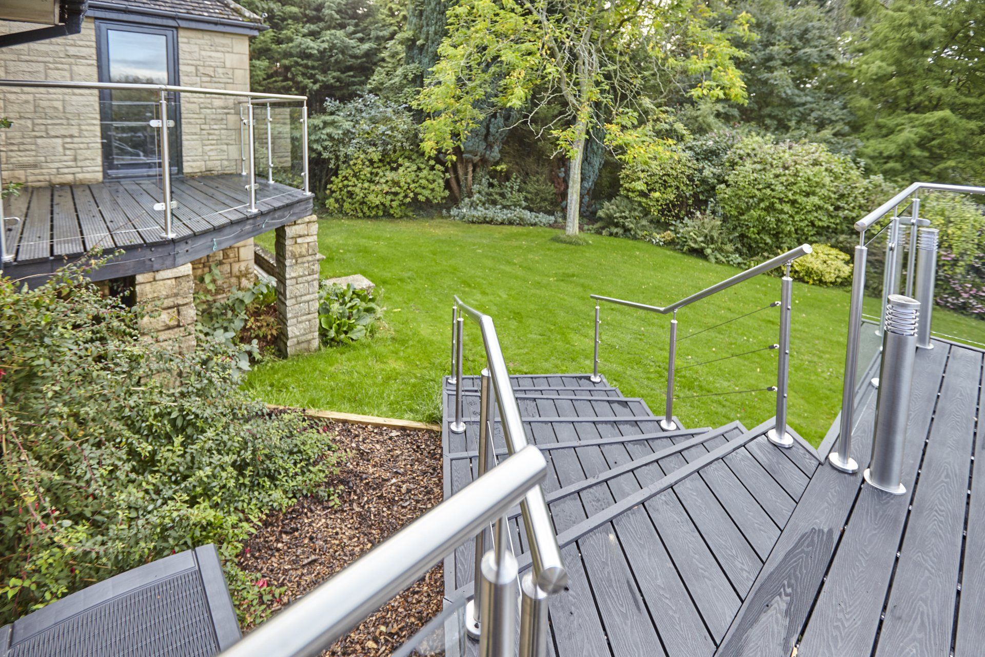 A set of stairs leading up to a lush green yard