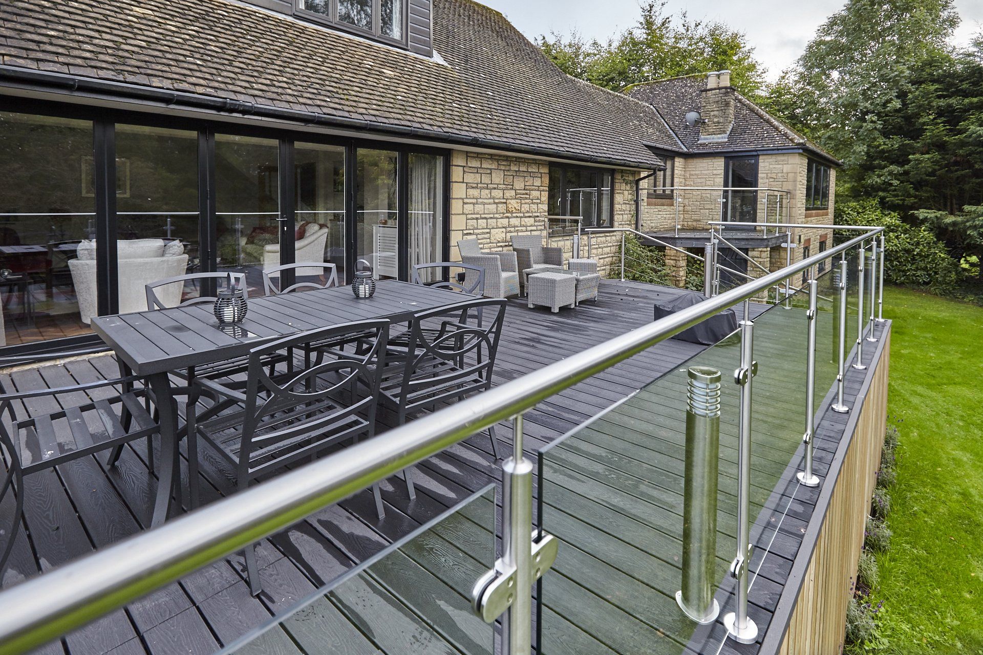A large deck with a table and chairs on it