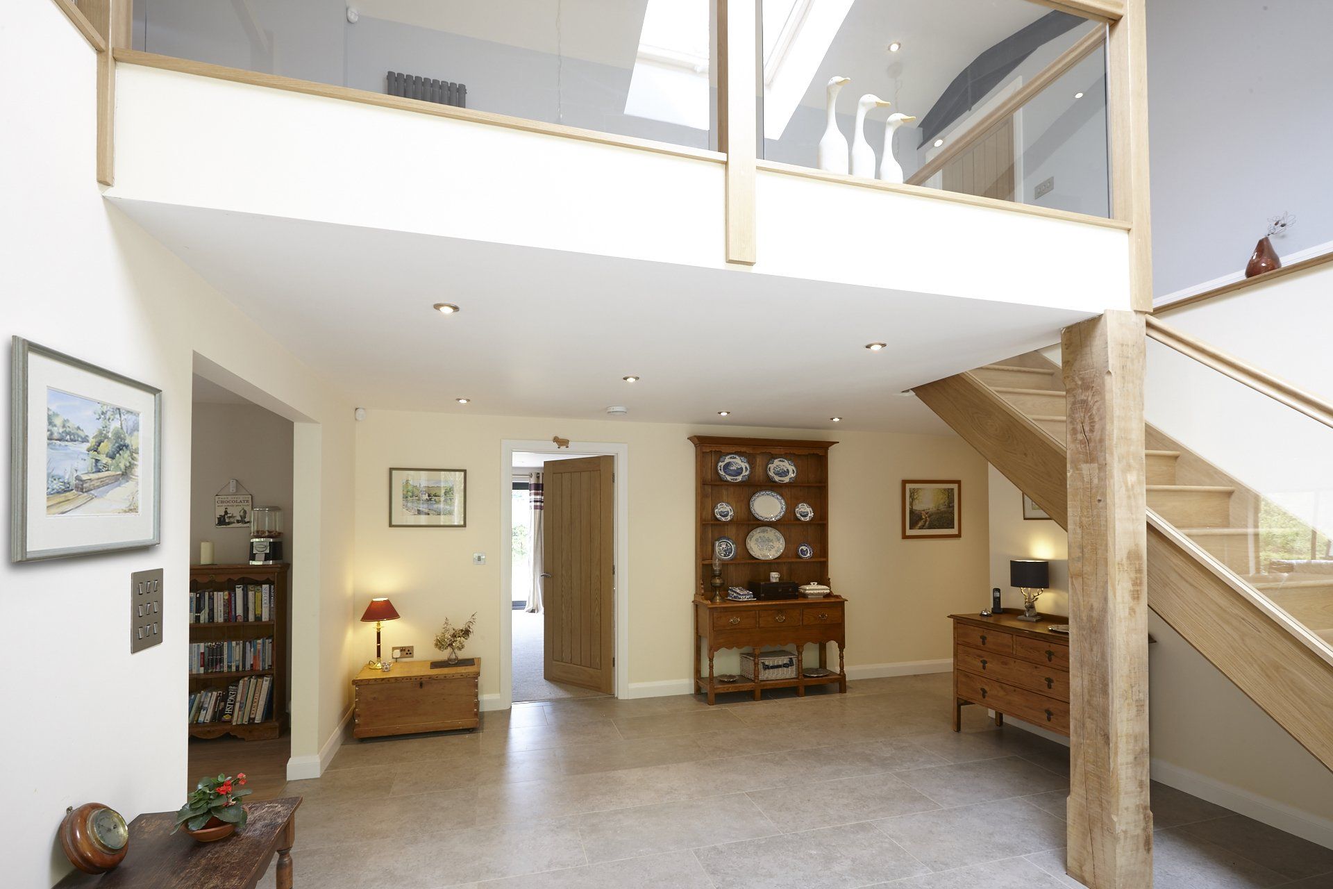 A hallway with a staircase leading up to the second floor
