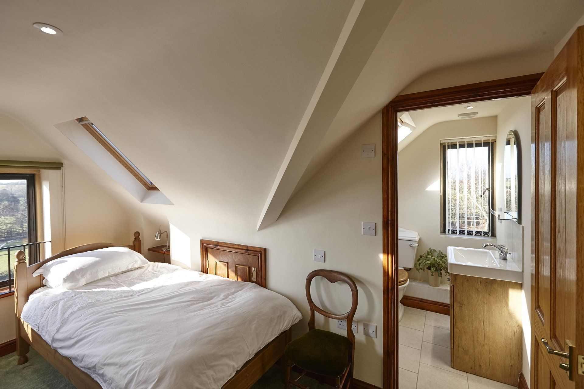 A bedroom with a king size bed and a bathroom