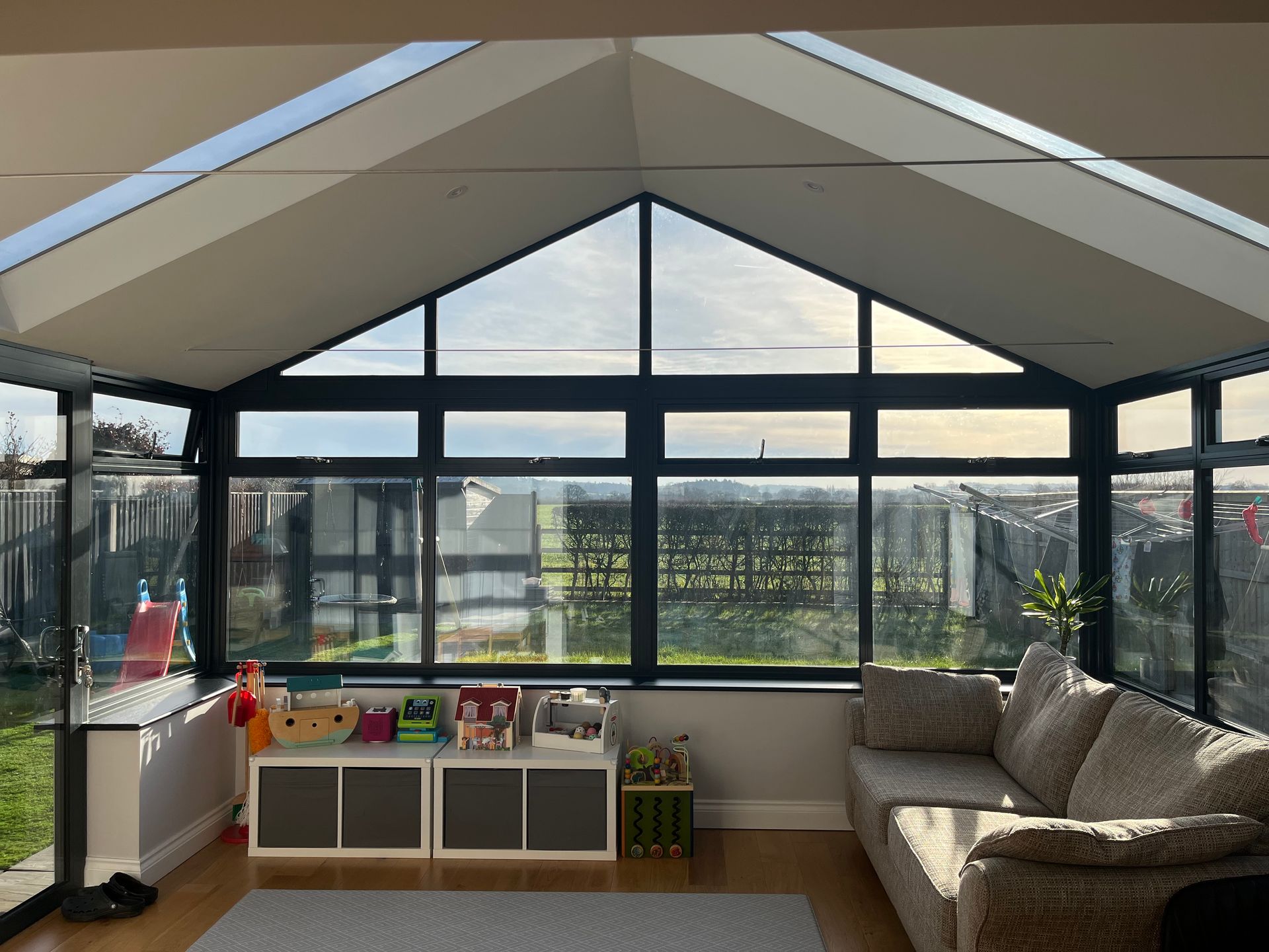 A living room with a couch and a lot of windows