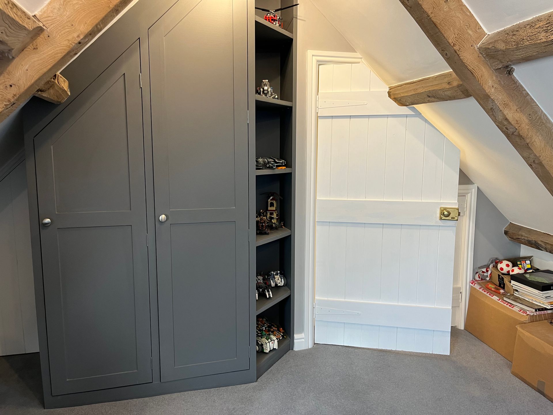 A room with a gray cabinet and a white door